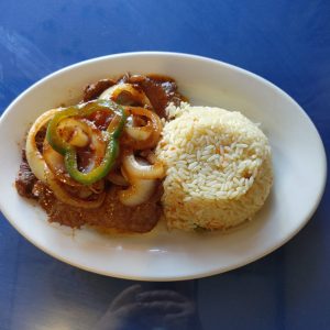 Beef steak encebollado. slow cooked sirlion, with pepers amd onions, light tonato broth, served with rice